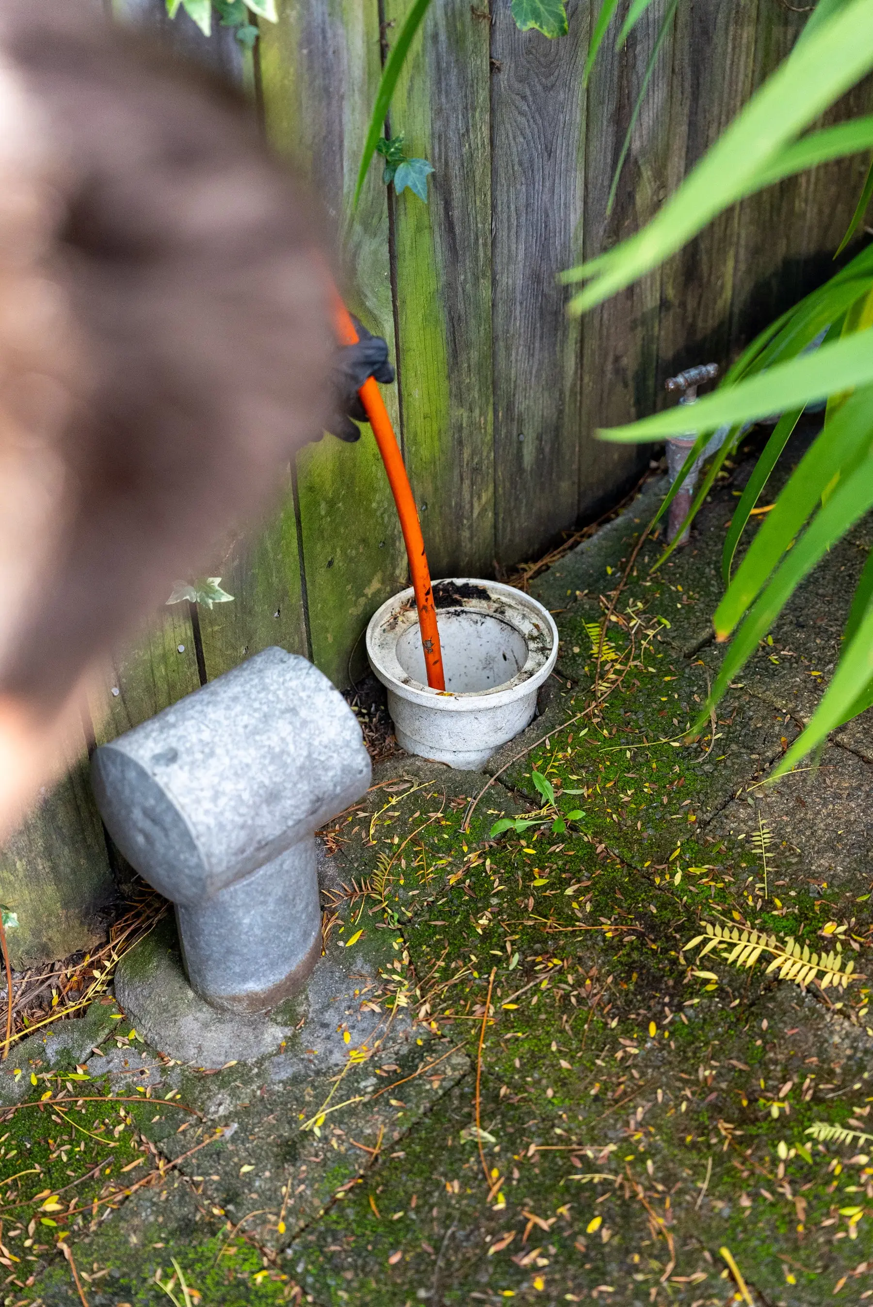 A blocked stormwater drain being cleared