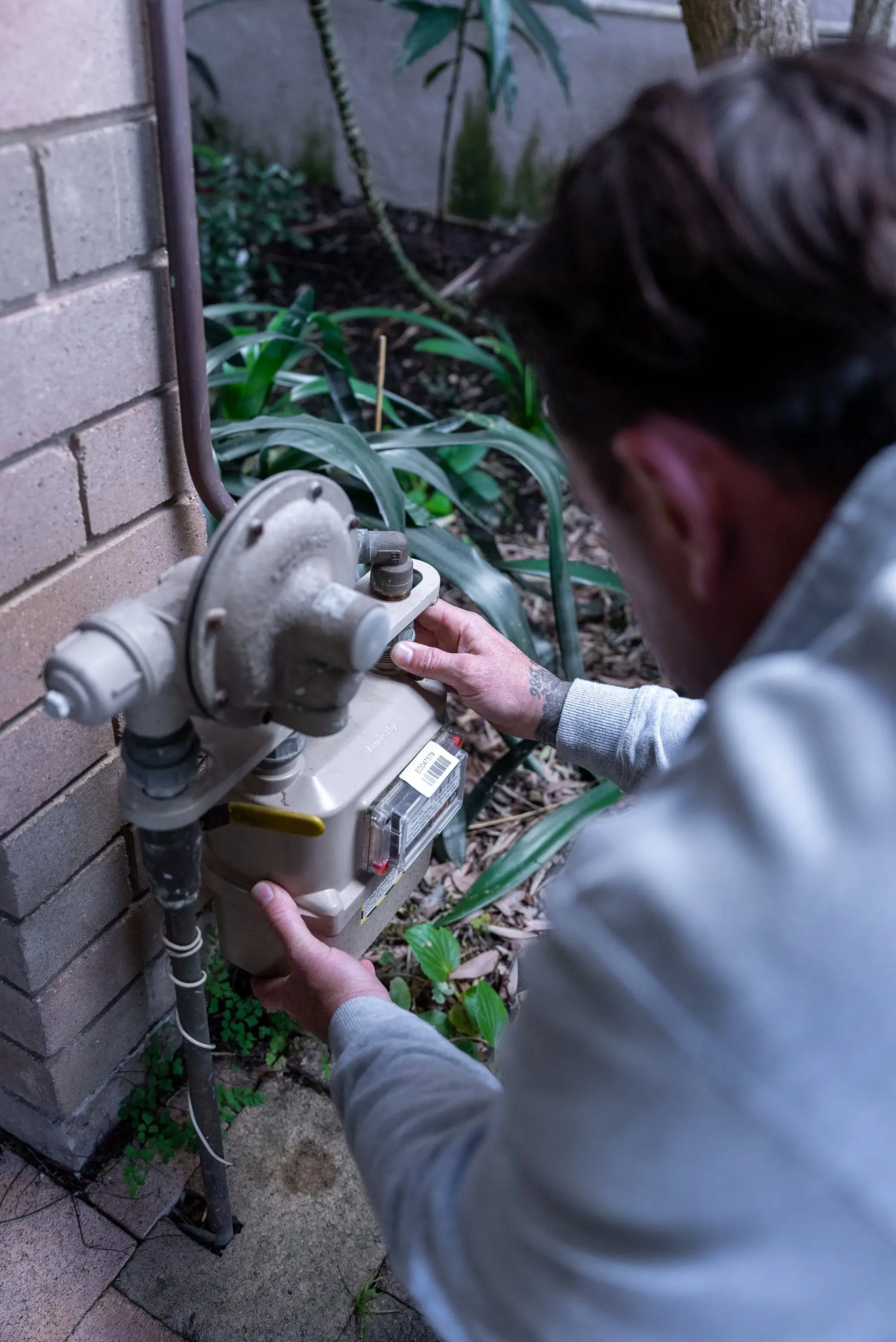A Plumbwell gas fitter working on a meter in Camperdown