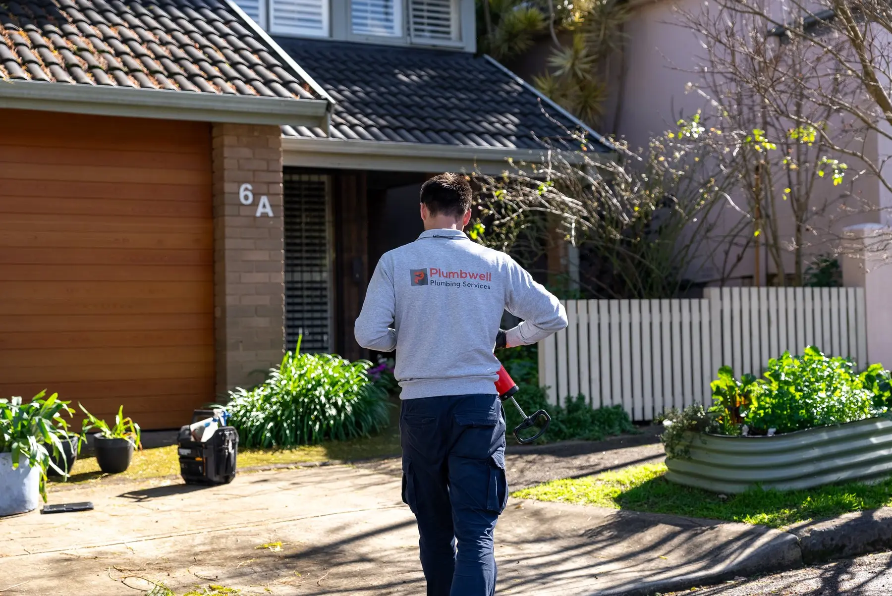 A Plumbwell plumber arriving at a Sydney home