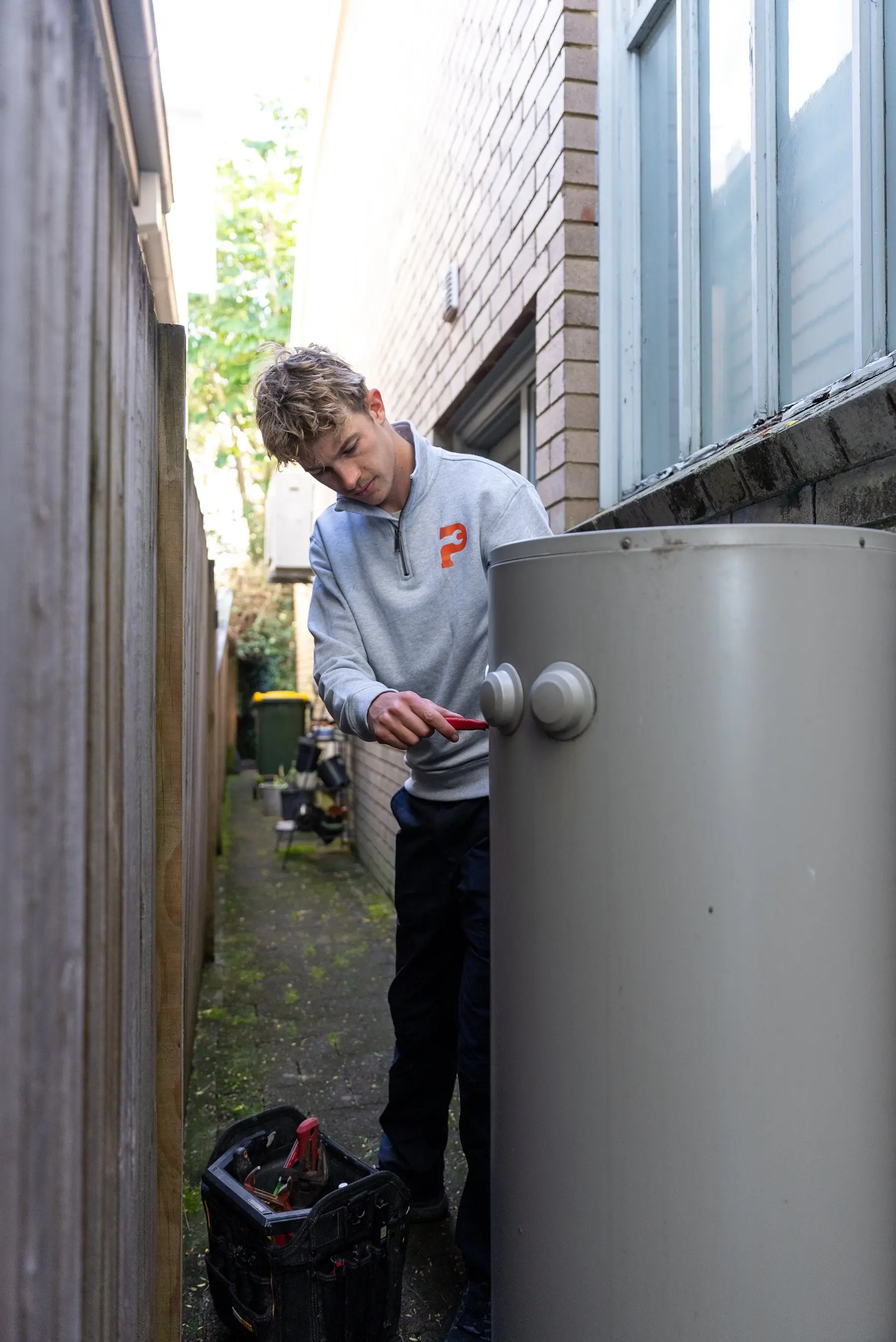 A Plumbwell plumber servicing a hot water system in Camperdown