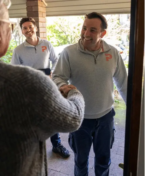 Two Plumbwell plumbers arriving at a customer’s home