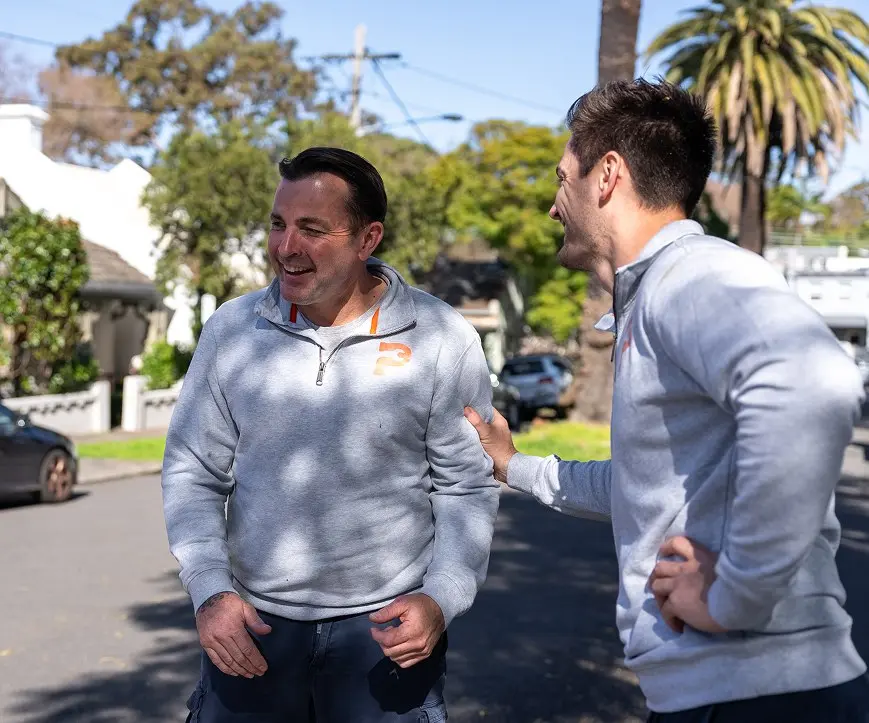 Sam from Plumbwell Plumbing Services greeting a colleague on a Sydney street